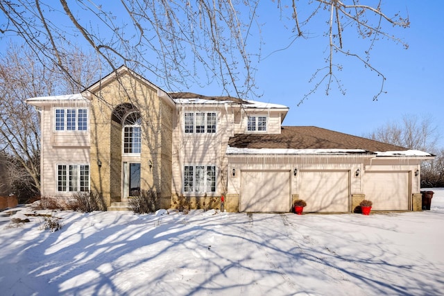 view of front of property with an attached garage and brick siding