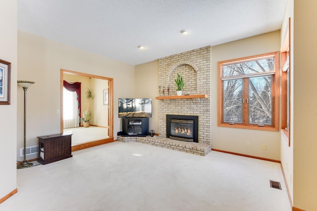 unfurnished living room with a fireplace, light colored carpet, and a textured ceiling