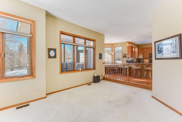 carpeted empty room with a textured ceiling