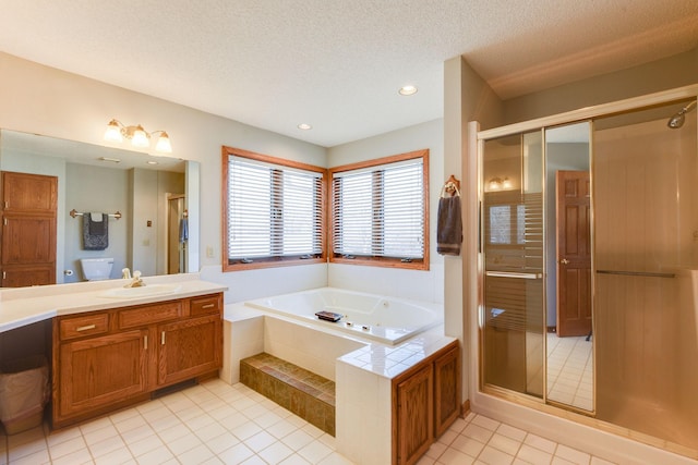 bathroom with vanity, independent shower and bath, tile patterned flooring, and a textured ceiling