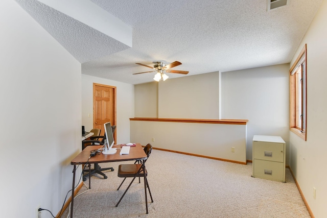 office with ceiling fan, light carpet, and a textured ceiling