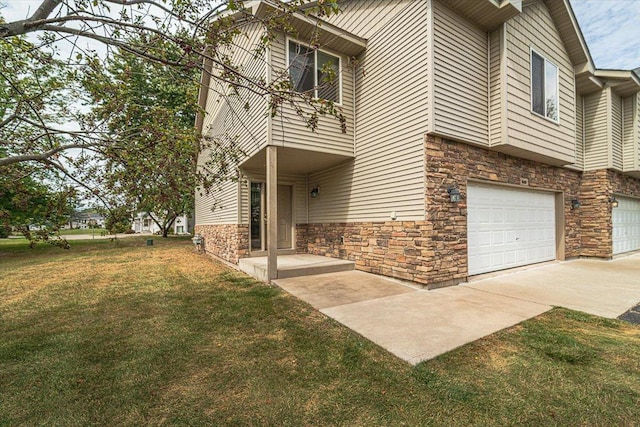 view of front of property with a front yard and a garage