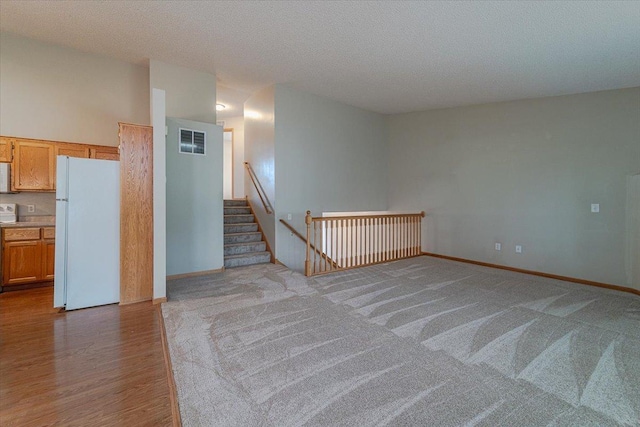 interior space featuring light hardwood / wood-style flooring and a textured ceiling