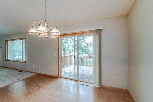 interior space featuring a chandelier and light hardwood / wood-style flooring