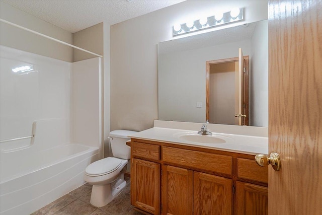 full bathroom featuring tile patterned floors, vanity, a textured ceiling, bathing tub / shower combination, and toilet