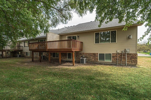 back of property featuring central AC, a wooden deck, and a lawn