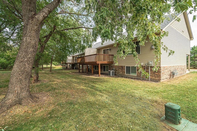 view of yard featuring central AC unit and a wooden deck