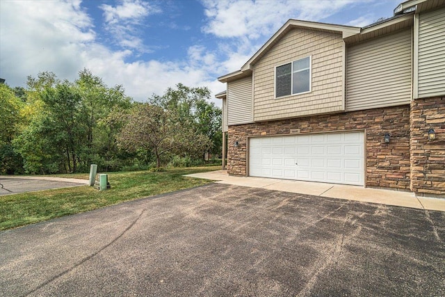 view of home's exterior featuring a lawn and a garage