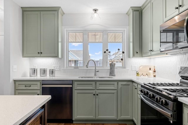 kitchen featuring sink, appliances with stainless steel finishes, and decorative backsplash