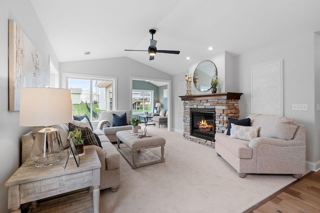 living room with a fireplace, lofted ceiling, wood-type flooring, and ceiling fan