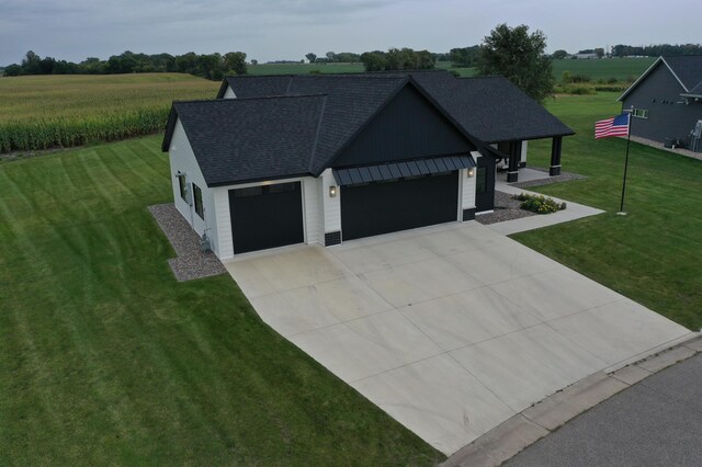 view of front of house featuring a garage and a front lawn