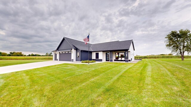 view of front of home featuring a garage and a front lawn