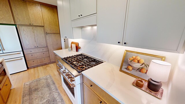 kitchen featuring light hardwood / wood-style flooring and white appliances