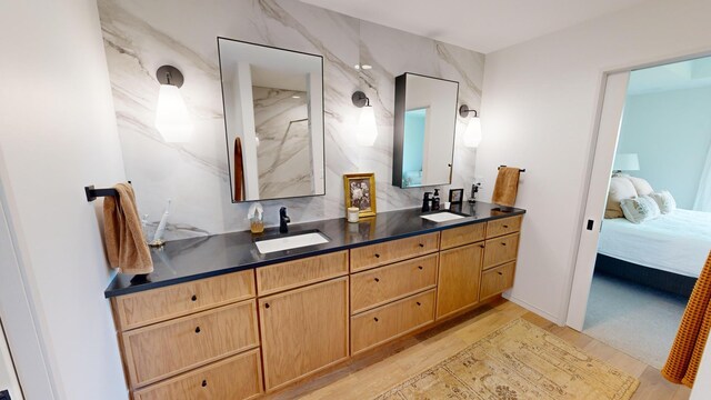 bathroom with a shower, vanity, and hardwood / wood-style flooring