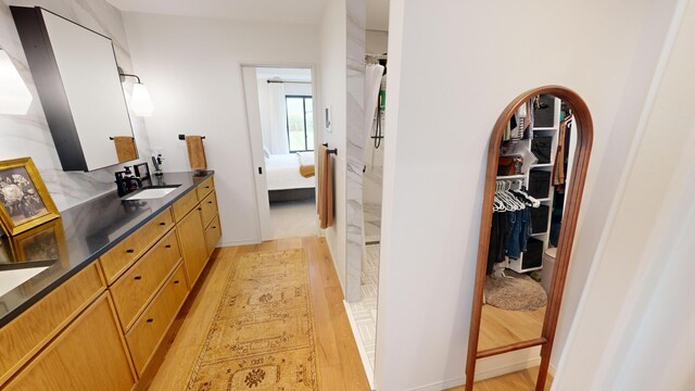 bathroom with vanity and hardwood / wood-style flooring