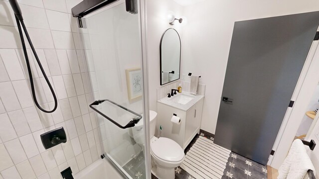 bathroom with vanity, toilet, and an enclosed shower