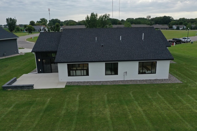 back of property featuring a yard and a patio area