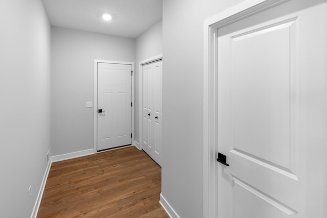 hall with baseboards and dark wood finished floors