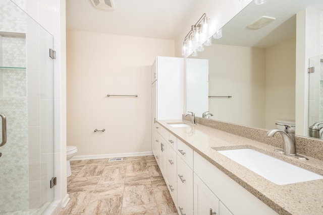 bathroom with toilet, an enclosed shower, and vanity