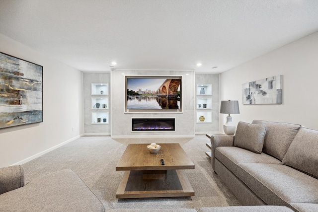 living room featuring built in shelves, a fireplace, and carpet floors