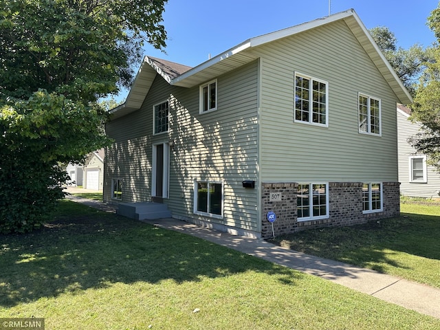 view of front of property with a garage and a front lawn