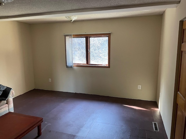 empty room featuring a textured ceiling