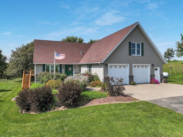 view of front of house featuring a front yard and a garage