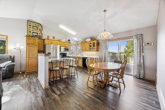 dining area featuring dark wood-type flooring, lofted ceiling, a notable chandelier, and a textured ceiling