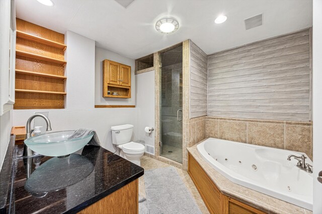 full bathroom featuring vanity, toilet, and separate shower and tub