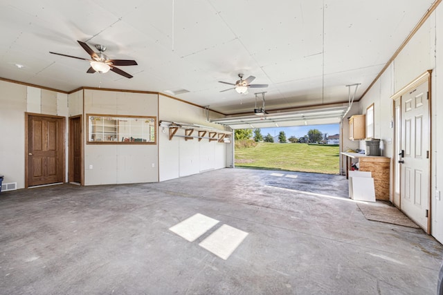 garage featuring ceiling fan, a lawn, and a garage door opener