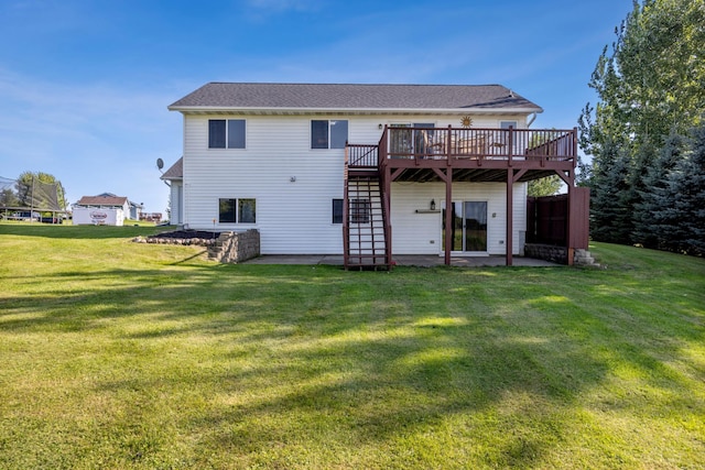 rear view of house featuring a lawn, a patio, and a deck