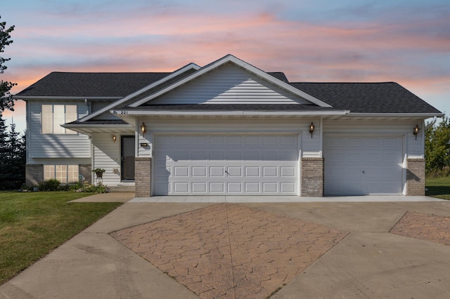 view of front of property featuring a lawn and a garage