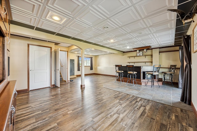 interior space featuring indoor bar and hardwood / wood-style flooring