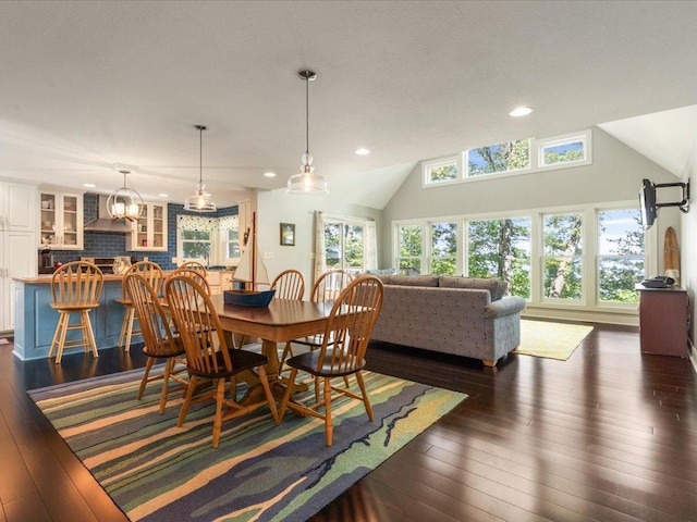 dining room featuring recessed lighting, lofted ceiling, and dark wood finished floors