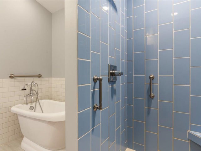 full bathroom featuring tiled shower, tile walls, and a freestanding tub