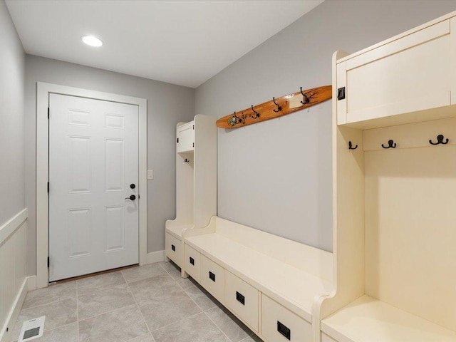 mudroom with light tile patterned floors, baseboards, and visible vents