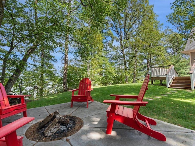 view of patio with a wooden deck, a fire pit, and stairway