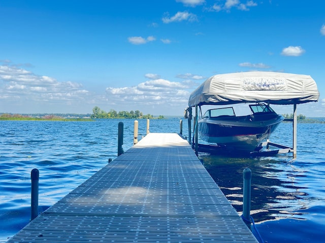 dock area with a water view and boat lift