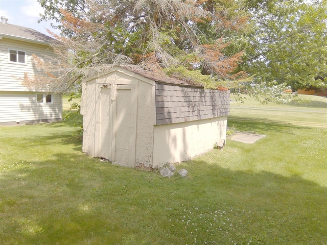 view of outbuilding featuring a yard
