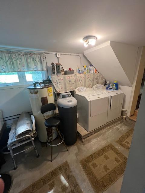 interior space featuring concrete flooring, water heater, and separate washer and dryer