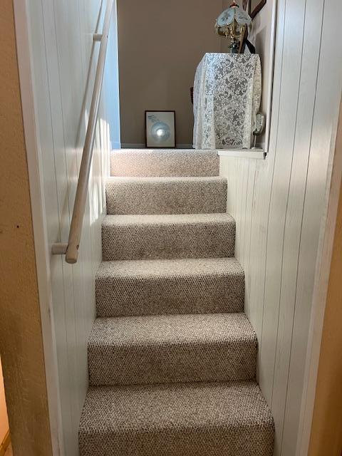 staircase with wood walls