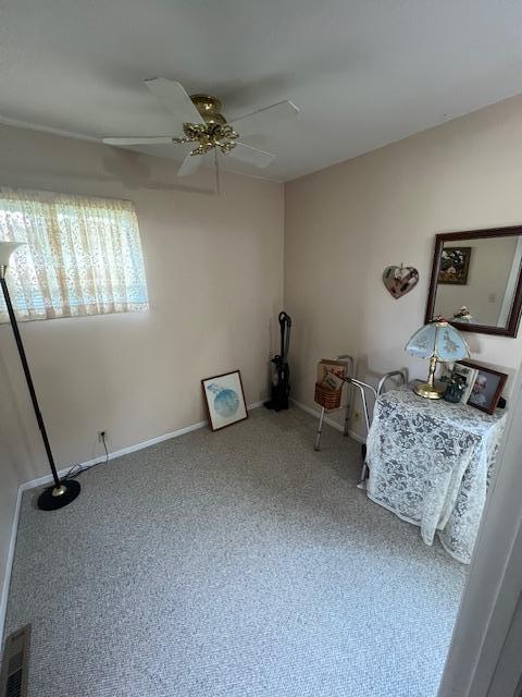 unfurnished room with ceiling fan and carpet flooring