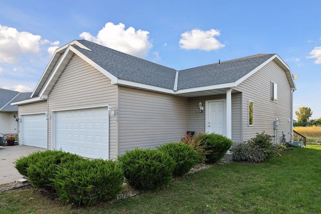 single story home with a garage and a front lawn