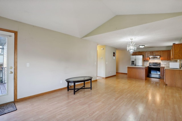 kitchen featuring pendant lighting, lofted ceiling, light hardwood / wood-style flooring, black electric range oven, and stainless steel fridge with ice dispenser