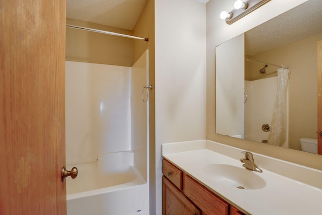 full bathroom with shower / tub combo, a textured ceiling, vanity, and toilet