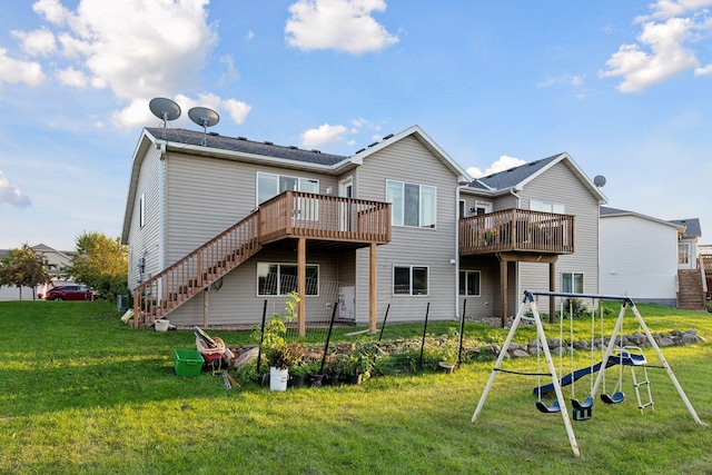 rear view of property with a deck and a lawn