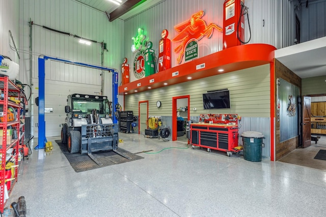 garage featuring wood walls