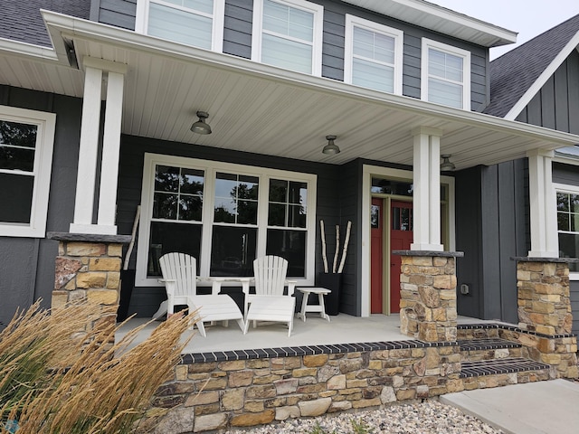 25002 State Highway 108, Lida Twp, MN 56572 - property entrance with stone siding, a shingled roof, covered porch, and board and batten siding