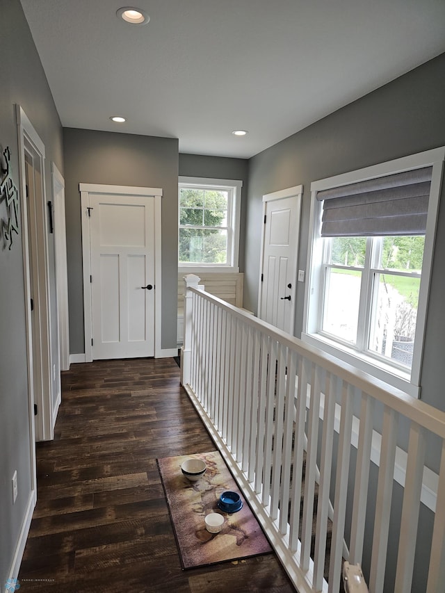 hallway with dark hardwood / wood-style flooring