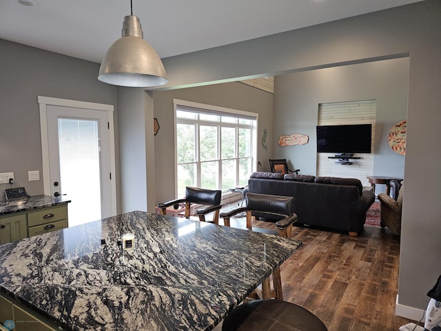 25002 State Highway 108, Lida Twp, MN 56572 - kitchen featuring hanging light fixtures, open floor plan, dark stone counters, and dark wood finished floors